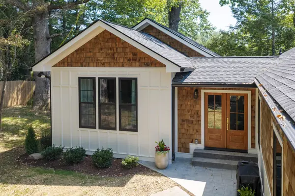 Front entry from the side, showing the cedar shake gable above the doors