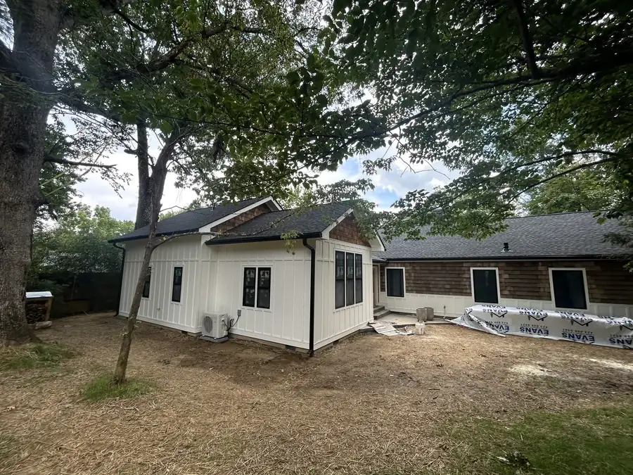 White board-and-batten home addition with cedar shake accents