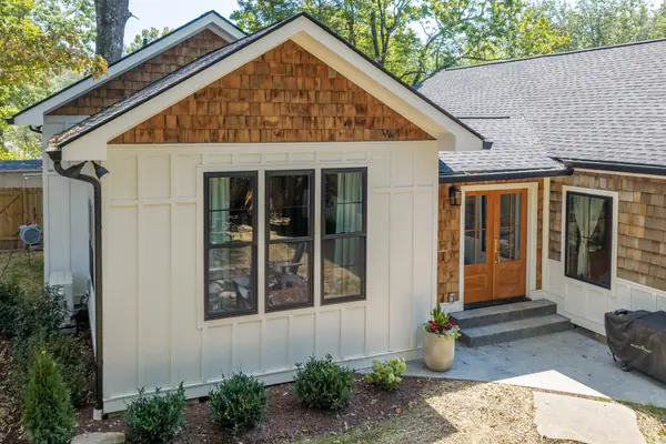 New front entry with wood double doors set into the board-and-batten wall
