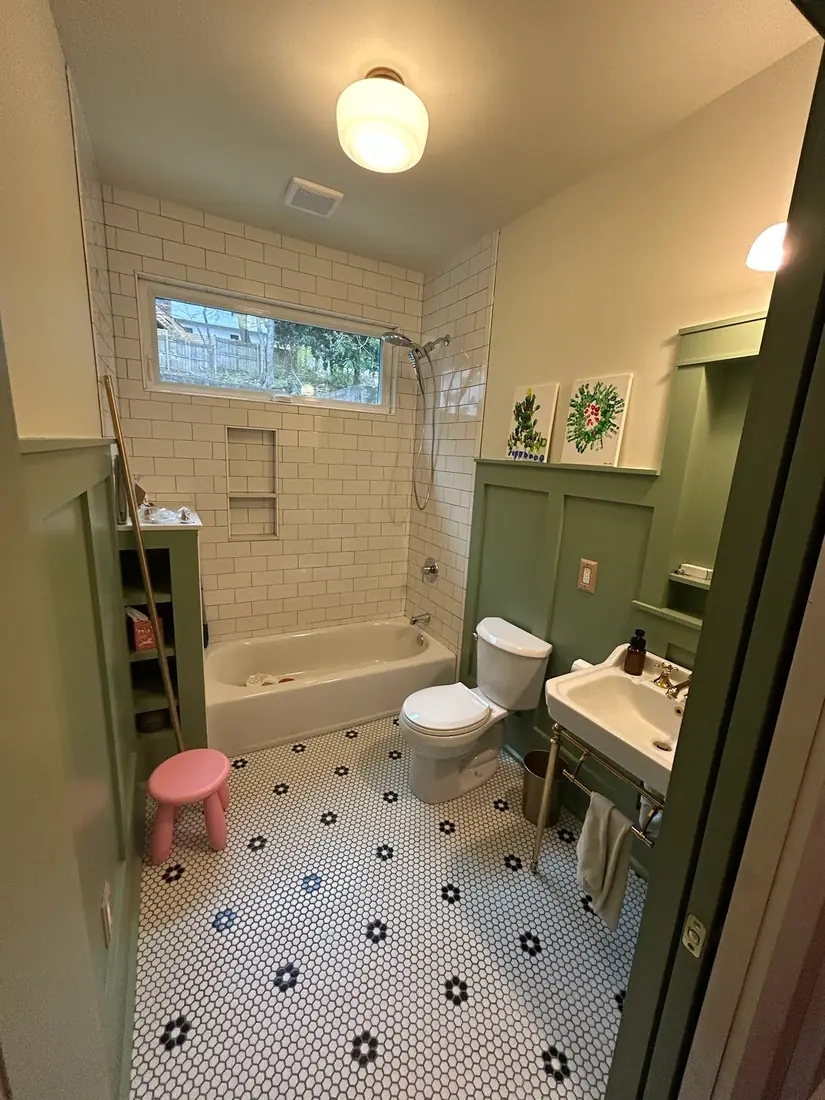 Craftsman bathroom remodel with green wainscot, subway tile and hex floor