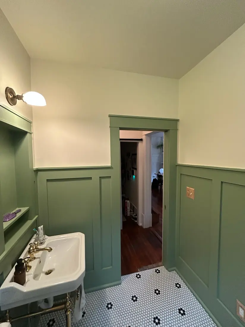 Green craftsman bath with console sink and pocket door