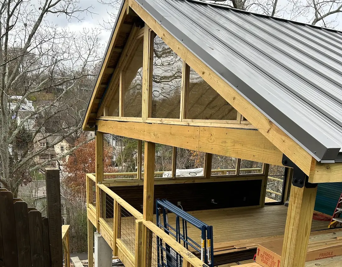 Timber-framed covered porch with metal roof