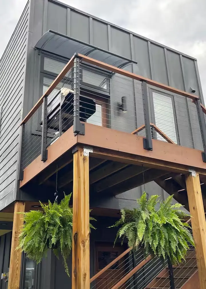 Detached garage and ADU with an elevated deck above the garage bay