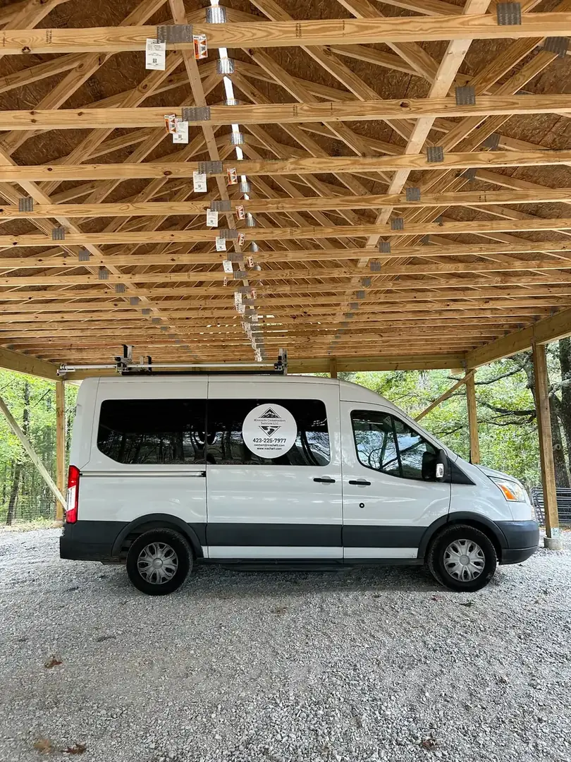 Truss and purlin framing seen from beneath the pole barn